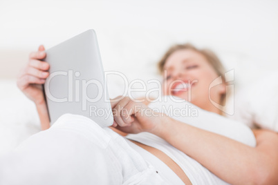 Woman laughing while using an ebook