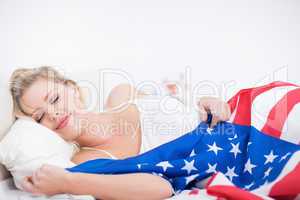 Blonde woman sleeping with a US flag