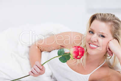 Young woman holding a beautiful rose