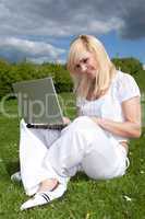 Portrait of a young blonde woman with a laptop