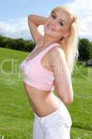 Fit young blonde woman in a pink top