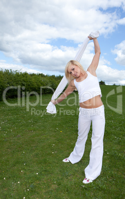 Pretty young blonde stretching arms