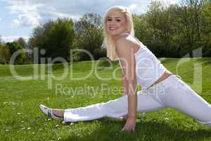 Young attractive blonde stretching outside