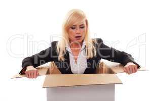 Scared young blonde getting out from a box