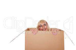 Smiling young blonde emerging from a box