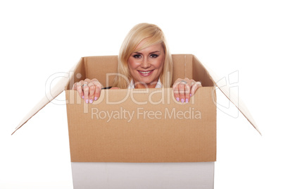 Attractive young blonde emerging from a box