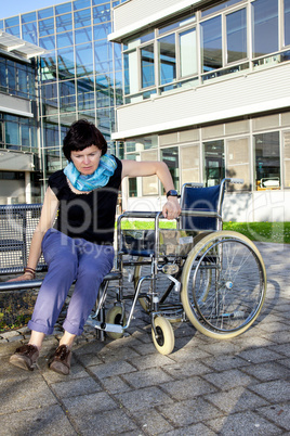 Woman tries to sit in a wheelchair