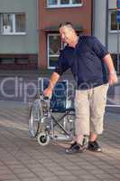 Man standing from the wheelchair to
