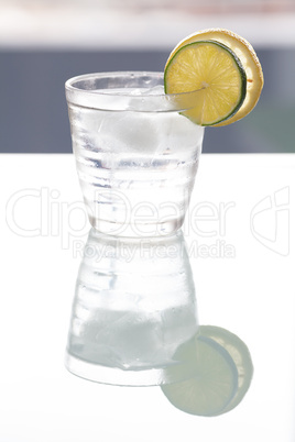 water with lemon and lime in a glass with ice