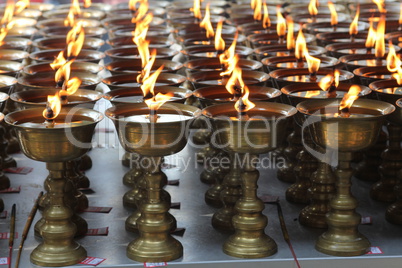 Candles burning in a Buddhist temple.