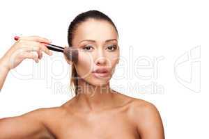 Young beautiful woman applying makeup