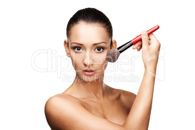 Young beautiful woman applying makeup