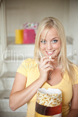 young woman eats popcorn