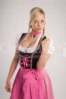 woman with dirndl warns with fist