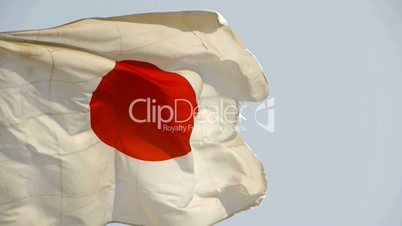 Japanese flag is fluttering in wind.