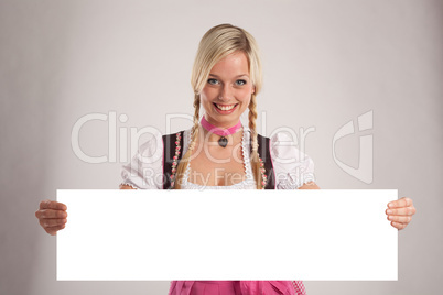 woman with dirndl holds an empty signboard