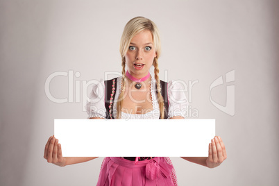 woman with dirndl holds an empty signboard