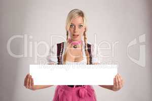 woman with dirndl holds an empty signboard