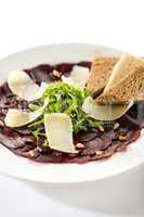 Vegetarian carpaccio with beetroot,nuts and toast