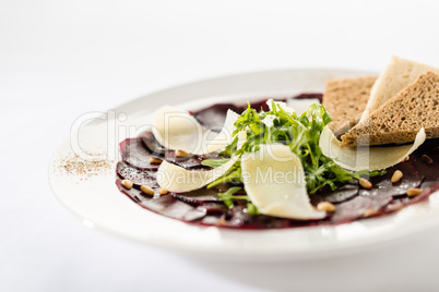 Vegetarian carpaccio with beetroot,nuts and toast