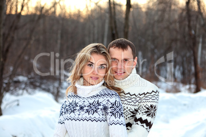 Happy pair in winter forest