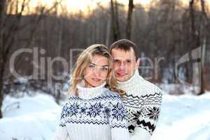 Happy pair in winter forest