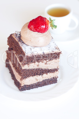 beautiful cake with strawberry and tea on a white background