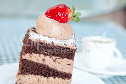 beautiful cake with strawberry and a cup of tea