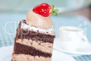 beautiful cake with strawberry and a cup of tea