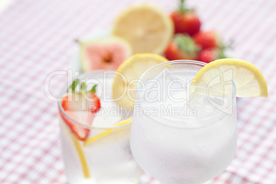 cocktail with ice,lemon, fig and strawberries on a plate