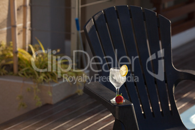 Swimming pool, lounge, a wine glass with ice, lemon and strawber