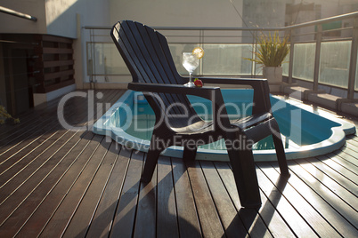 Swimming pool, lounge, a wine glass with ice, lemon and strawber