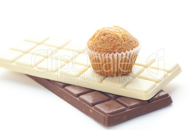 bar of chocolate and muffin isolated on white