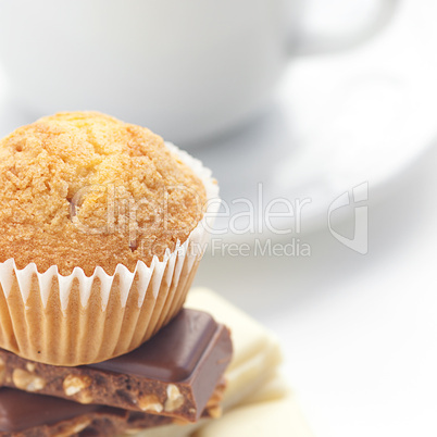 bar of chocolate,tea and muffin isolated on white