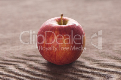 apple lying on brown mat