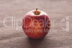 apple lying on brown mat