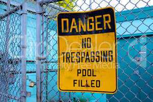 Danger No Trespassing Pool Filled Sign Outside Pool