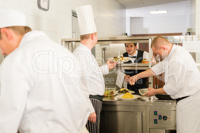 Professional kitchen cook prepare meal give waiter