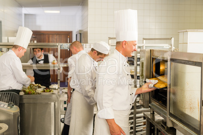 Group of cooks in professional kitchen