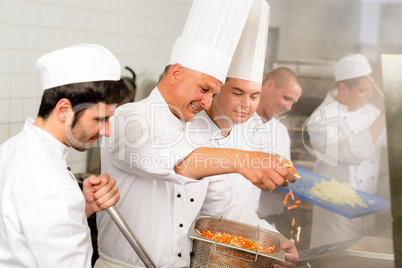 Two professional chefs cooking in kitchen