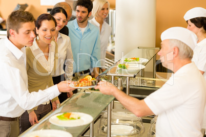 Office colleagues in canteen cook serve meals