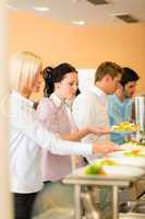 Young business colleagues queue canteen lunch