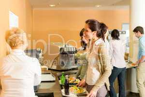 Cafeteria pay at cashier women in queue