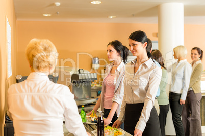 Cafeteria pay at cashier women in queue