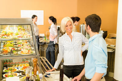 Business colleagues at cafeteria chatting