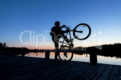 Silhouette of a Cyclist on the Sunset Sky