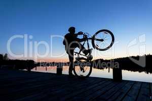 Silhouette of a Cyclist on the Sunset Sky