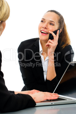 two women during a business meeting with laptop on white backgro