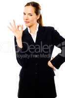 young businesswoman with her hand indicating ok on white backgro