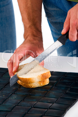 hands of a man who cuts the bread